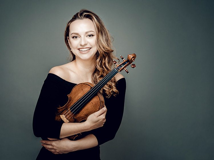 Maria Ioudenitch smiling, holding her violin. Photo by Andrej Grilc.