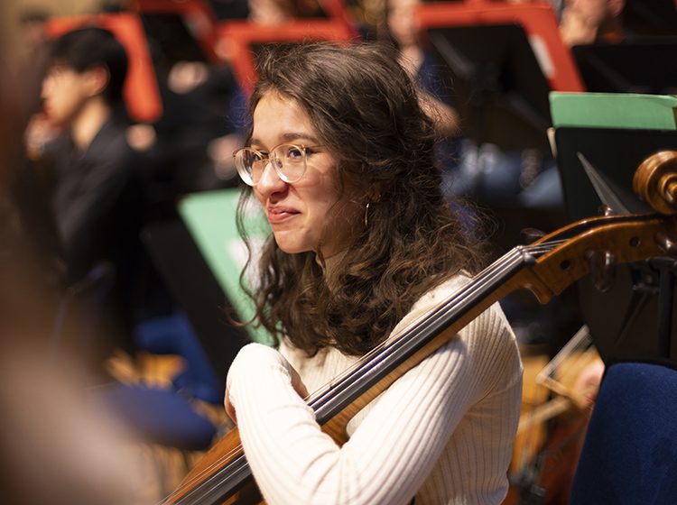 A cello player in the Junior Academy Symphony Orchestra