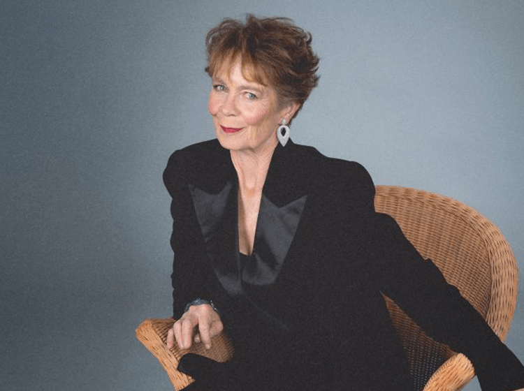 Celia Imrie CBE sitting down and smiling