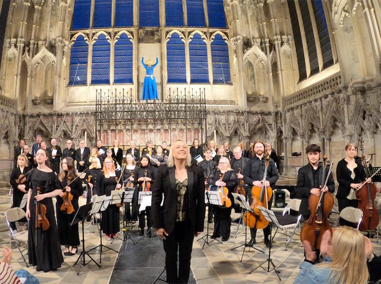 Susannah Self with North Sea Voices and Orchestra taking applause in Ely Cathedral